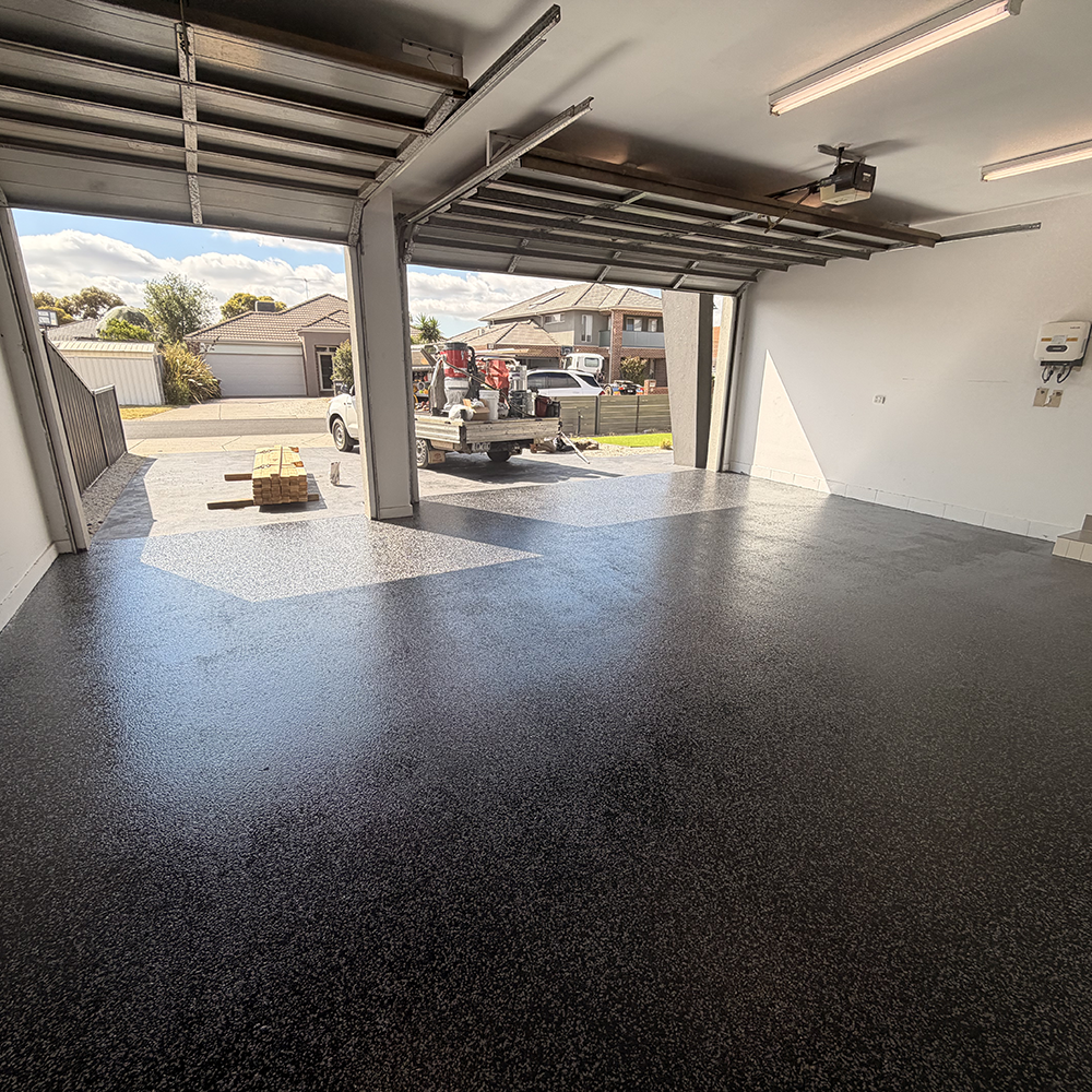 Epoxy garage floor — dark charcoal flake finish