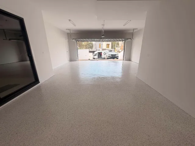 Epoxy garage floor — dark charcoal flake finish